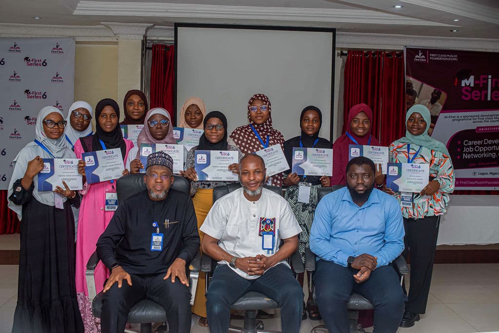 Female graduates from M-First Series holding their certificates