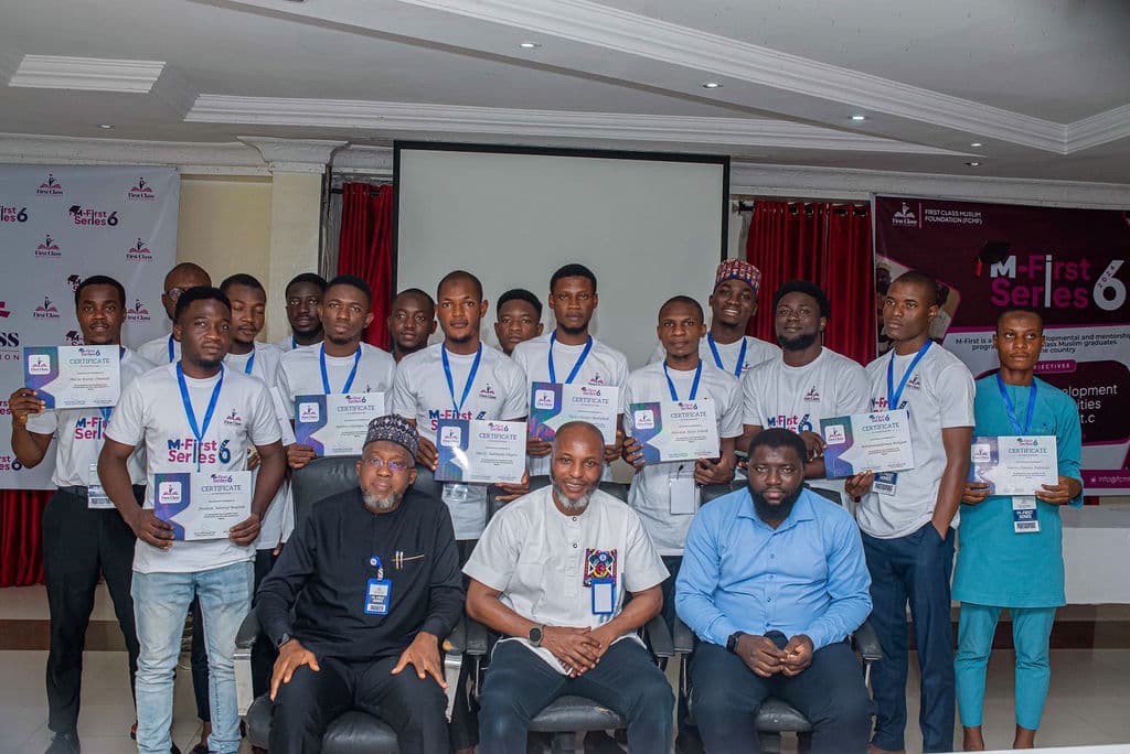 Male graduates from M-First Series holding their certificates